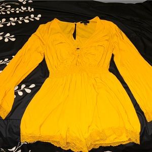 Flowy long sleeve yellow romper with lace embellishments